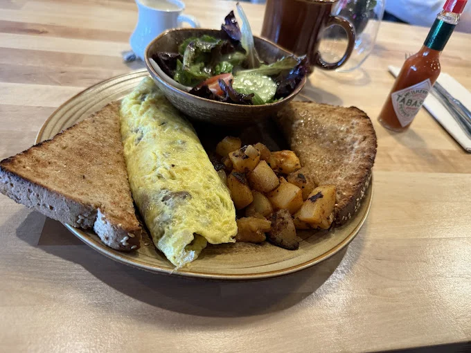Omelette with toast, roasted potato hash and a side salad