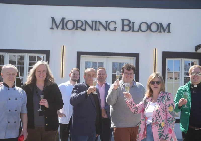 Morning Bloom team and guests toasting in front of the storefront in Allendale